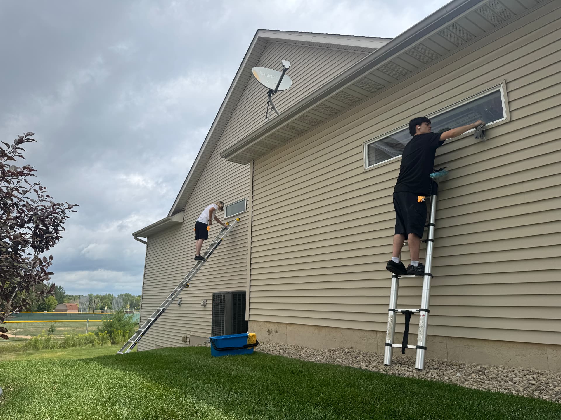 Prime Shine Cleaning technician working on a window cleaning project