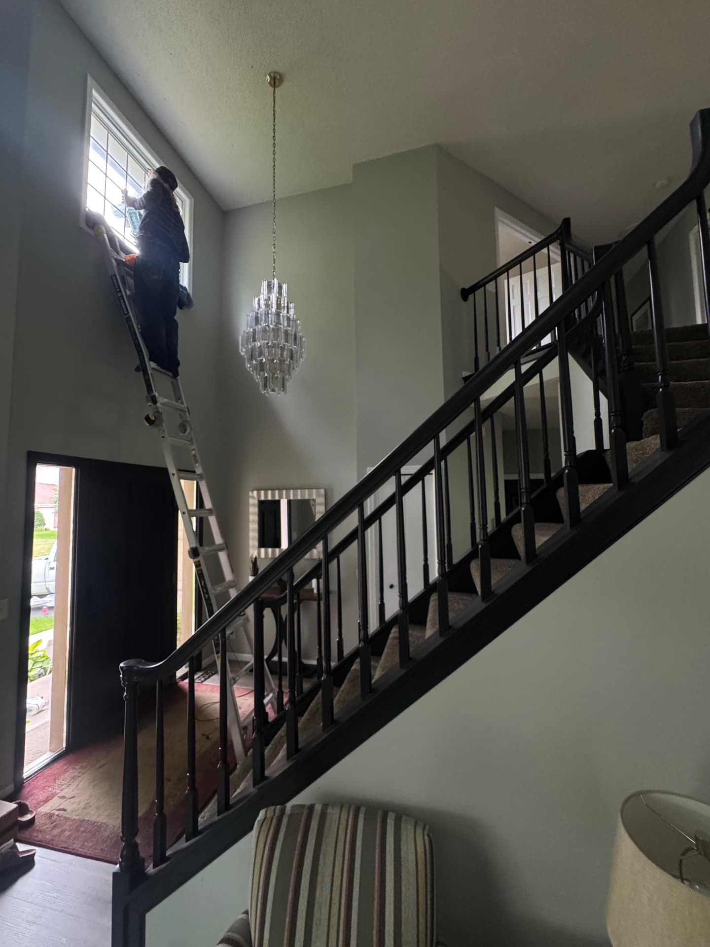 Prime Shine Cleaning working on an interior window