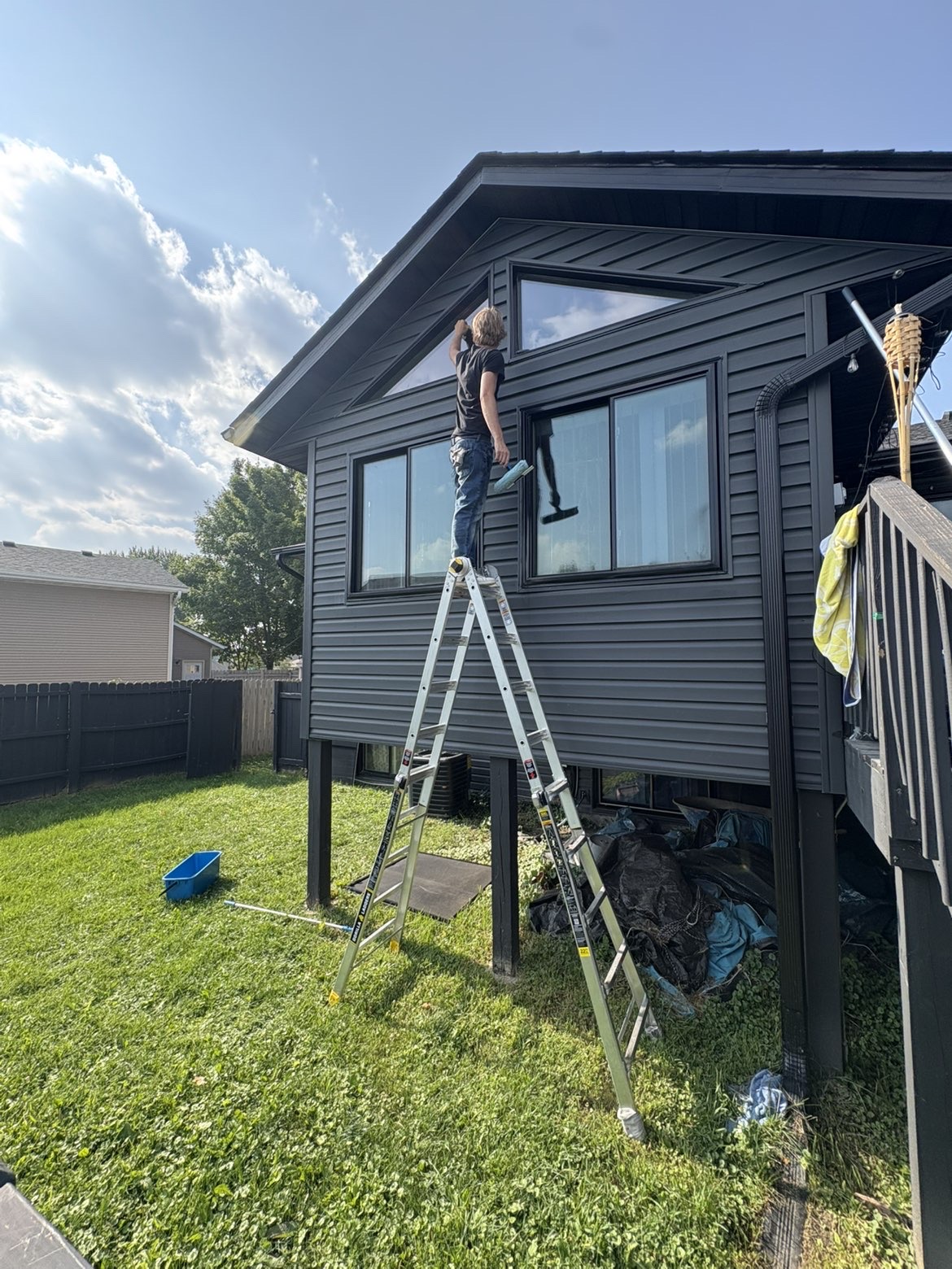 Prime Shine Cleaning technician cleaning high residential windows